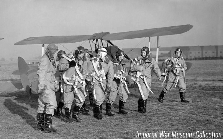Early ATA Women’s Section pilots walking past De Havilland Tiger Moths